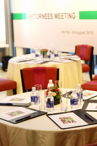 a table with glasses and bottles on top of it at Mercure Hanoi La Gare Hotel in Hanoi
