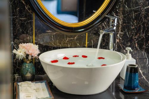 a sink with red hearts in it in a bathroom at Overnight Cruise in Hai Phong