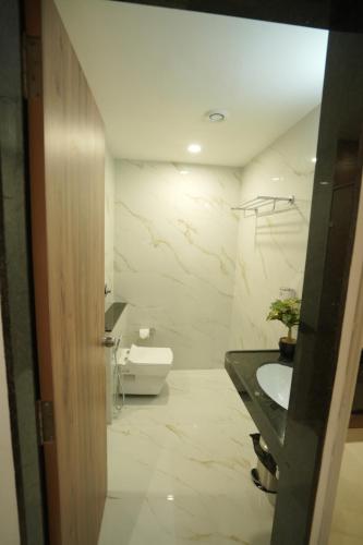 a bathroom with a sink and a toilet at The Grand Icon in Chandrapur