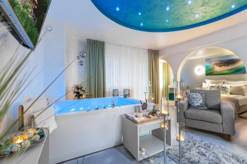 a large bathroom with a tub and a bed at Elegante Apartments & Jacuzzi Władysławowo - Adults Only in Władysławowo