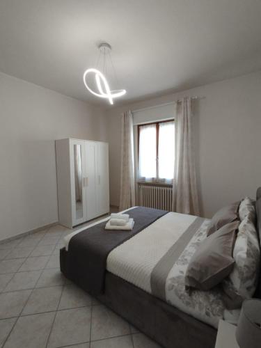 a bedroom with a large bed and a window at Casa Spartaco in Certaldo