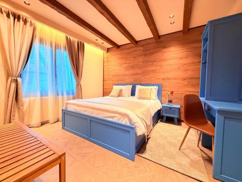 a bedroom with a blue bed and a window at DG kores in Metsovo
