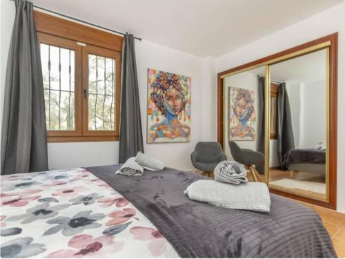 a bedroom with a large bed and a mirror at Finca Azahar in Sant Jordi