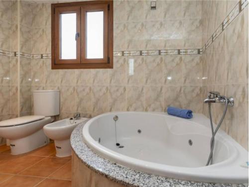 a bathroom with a bath tub and a toilet at Finca Azahar in Sant Jordi