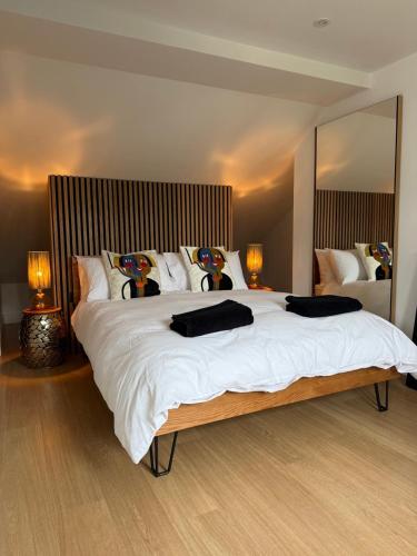 a bedroom with a large white bed with two lamps at Stay in Style, Two Bed! in Appleford