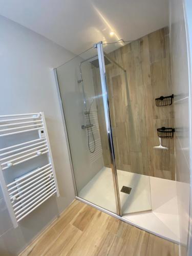 a shower with a glass door in a bathroom at Baionako extea in Bayonne