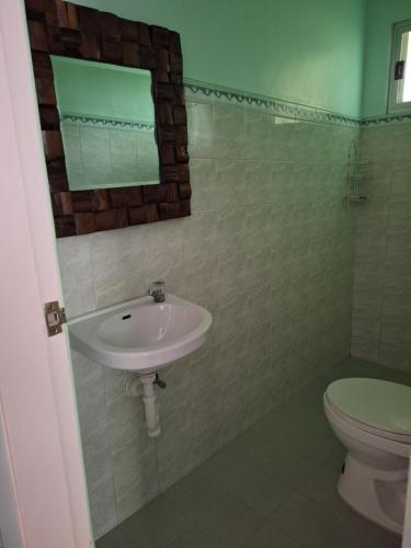 a bathroom with a sink and a toilet at Ngak-Ngak Beach Resort in Calatrava