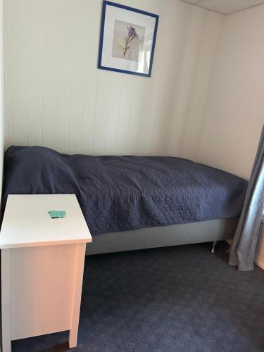 a room with a bed and a table in it at Fanaseter in Bergen