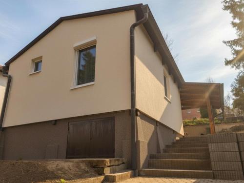 a house with a door and some stairs at Igali Kuckó in Igal
