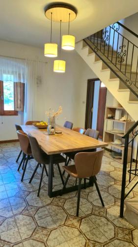 a dining room with a wooden table and chairs at Paradiso Privato di Modolo in Modolo