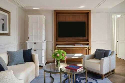 a living room with a couch and a tv at The St. Regis Budapest in Budapest