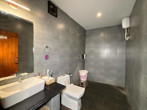 a bathroom with a sink and a toilet at White Turtle Resort in Morjim