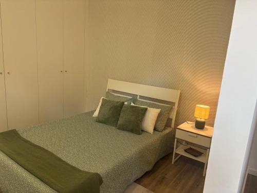a small bedroom with a bed and a night stand at AnaSol2 in Esposende