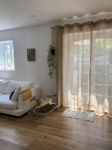 a living room with a couch and a window at Baionako extea in Bayonne
