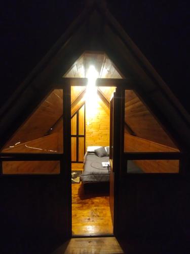 a room with a bed and a light in the attic at Cabañas tipo glamping in Moniquirá
