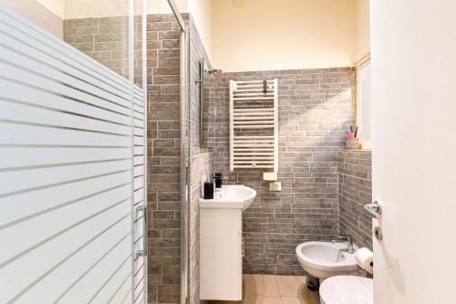a bathroom with a sink and a toilet in it at Casa Anastasia with private patio by GardaDoma in Brenzone sul Garda