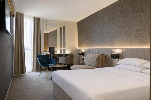 a hotel room with a bed and a desk at Hotel Bosna Banja Luka in Banja Luka