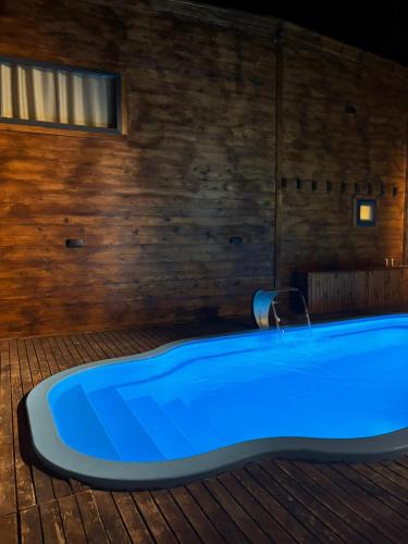 a blue bath tub in a room with a wooden wall at Villa Maris in Demre
