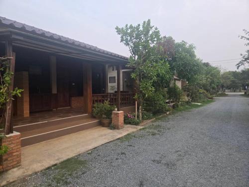 a house with a driveway in front of it at Cocoa Hut in Mae Chan