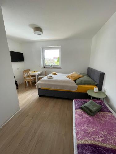 a bedroom with a bed and a table and a chair at Haus Friedau in Ellmau