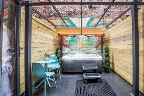 a bathroom with a tub and a table and chairs at Duke Street Boutique Hotel in Liverpool