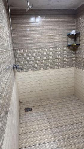 a bathroom with a shower with a tile shower at Hotel Lords Inn in Lahore