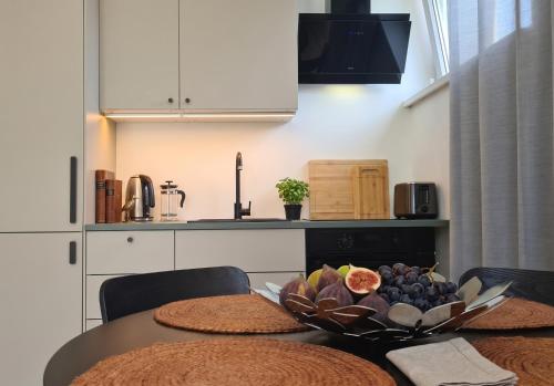 a kitchen with a table with a bowl of fruit on it at Hiiu korter Kärdlas in Kärdla