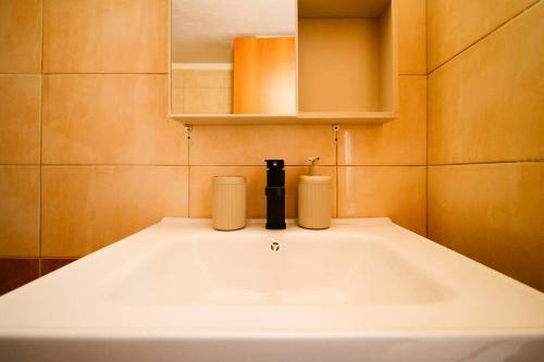a bathroom with a sink with two candles on it at Coastal nest in Perea