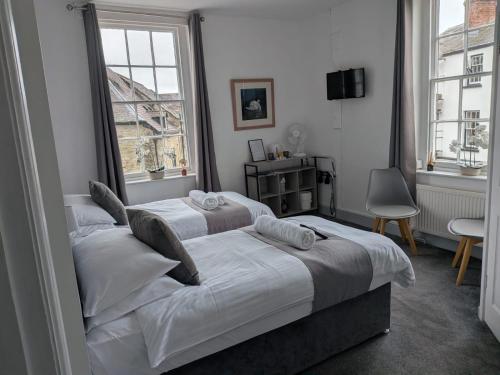 a bedroom with two beds and a window at The Swan Hotel in Kington