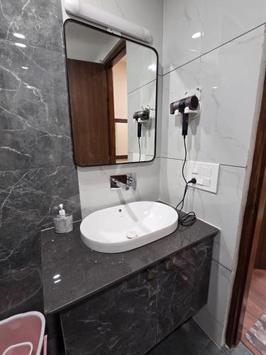 a bathroom with a sink and a mirror at Ganges Abode in Haridwār