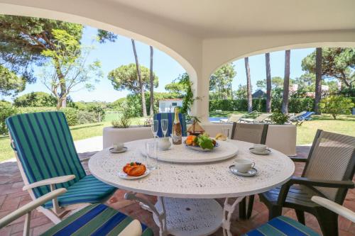 a table with food and drinks on a patio with chairs at Villa Joselina by Algarve Holidays in Vilamoura