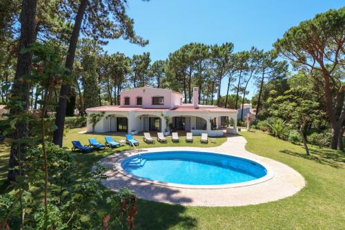 a house with a swimming pool in the yard at Villa Joselina by Algarve Holidays in Vilamoura