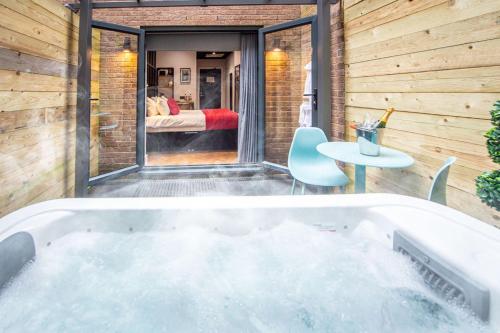 a bath tub in a room with a bedroom at Duke Street Boutique Hotel in Liverpool