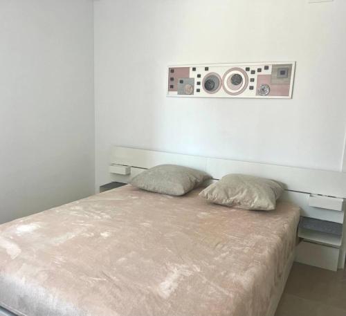 a bedroom with a bed with two pillows and two speakers at Marina Luxury in Torrevieja