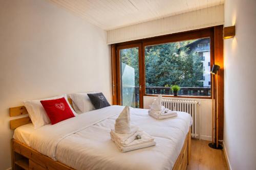 a bedroom with a bed with two sand castles on it at Superbe T3 en face du Brevent, Chamonix in Chamonix