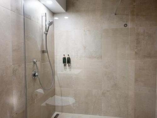 a bathroom with a shower with two bottles on a shelf at Hotel Cvilín in Krnov