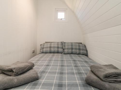 a small bedroom with a bed in a attic at Starlight Sanctuary in Malton