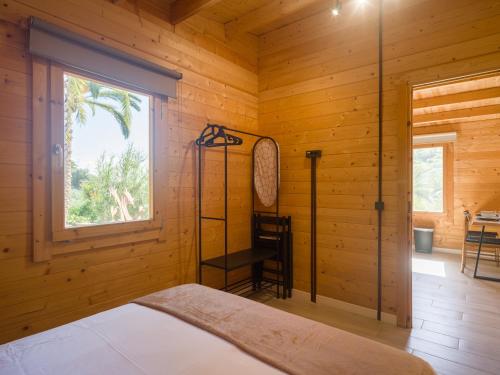 a bedroom with a bed in a wooden room at Rustic Home By CanariasGetaway in Telde
