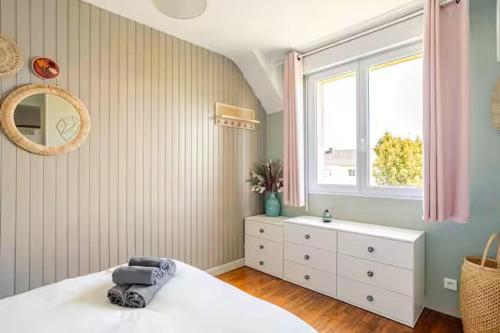 a bedroom with a white bed and a window at Grande maison familiale centre ville - 2km des plages in Beaussais sur Mer