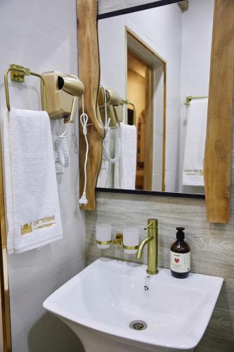 a bathroom with a sink and a mirror at Hotel Old Heritage in Tashkent