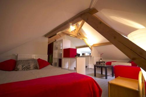ein Schlafzimmer mit einem roten Bett auf dem Dachboden in der Unterkunft Morges House in Morges