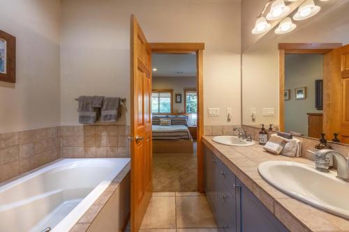 a bathroom with two sinks and a large tub at River Scene 30 Night Minimum in White Salmon