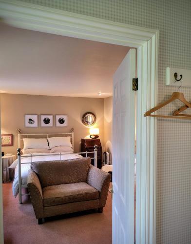 a bedroom with a bed and a couch in it at Apple Tree View in Coulston