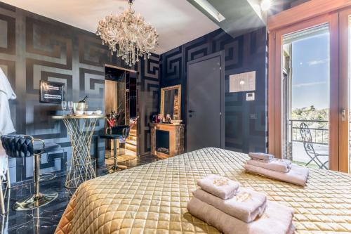 a bedroom with a bed with two towels on it at Int 37 Luxury Rooms in Rome
