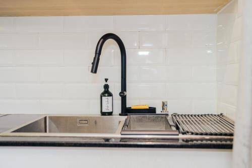 a bottle of wine sitting on a kitchen sink at Oaklands Tin Nest in Ruiru