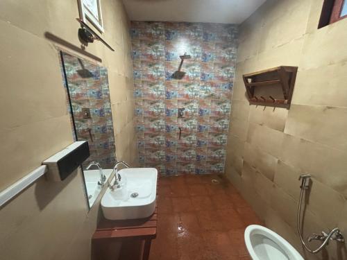 a bathroom with a sink and a toilet at Hotel YAN Residency Bhimtal - Nainital in Bhīm Tāl