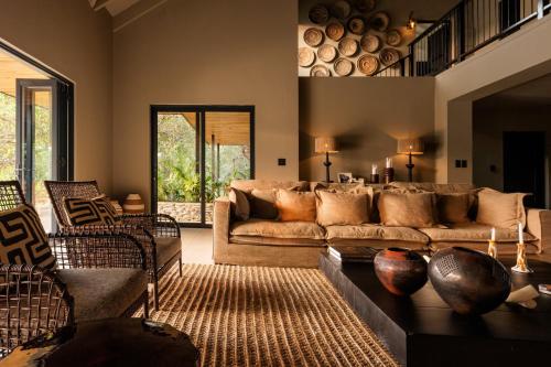 a living room with a couch and a table at Ujima Lodge in Hoedspruit