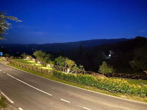 a road with a view of a mountain at night at L'Orto di Scarpaccia in Pratovecchio