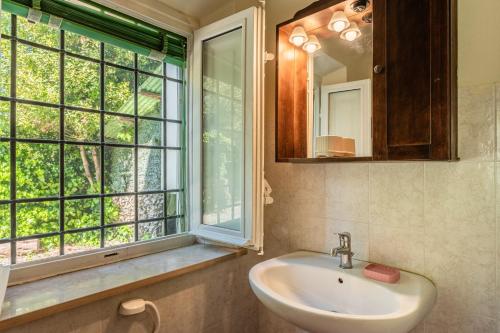 a bathroom with a sink and a window at Casa Anita Lucca in Lucca