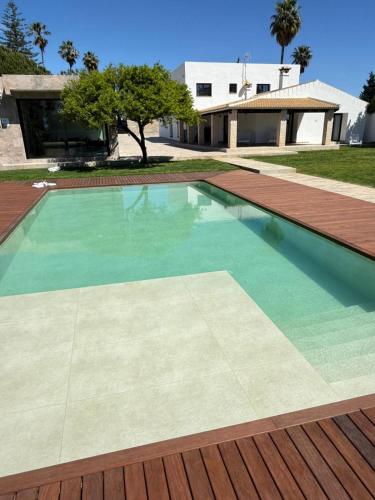 a swimming pool in front of a house at Villa Paraíso in Seville